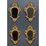 A set of four 19th Century Tuscan gilt framed wall mirrors with decorative scrolling ornamentEach