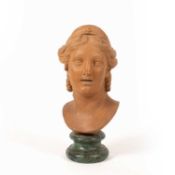 A terracotta female bust after the antique, the lady with her hair tied back and wearing a tiara,