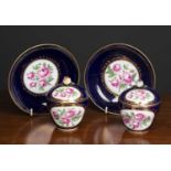 A pair of 19th century Sevres porcelain custard cups, covers and saucers decorated with pink roses
