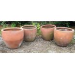 A set of four terracotta flower pots, 50cm diameter x 45cm high (4)Condition report: Weathered