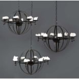 A set of three black painted wrought iron globular eight light chandeliers, each approximately