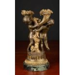 An antique French parcel-gilt bronze candelabrum with cherub supports and on a marble socle, 29cm