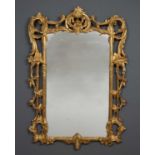 A gilt George III style wall mirror with rocaille ornament, 72cm wide x 108.5cm highCondition