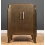 A contemporary continental bronzed two door side cabinet with stepped top, outset front corners