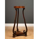 A William IV rosewood jardiniere with circular recessed top, on three scrolling supports, a