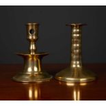 A mid to late 17th century brass candlestick with turned stem and spreading base, 9.5cm diameter x