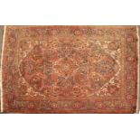 A late 20th century Middle Eastern red ground rug with a banded border, geometric foliate