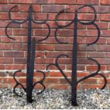 A pair of old possibly Medieval wrought iron door hinges with scrolling ornament, each approximately