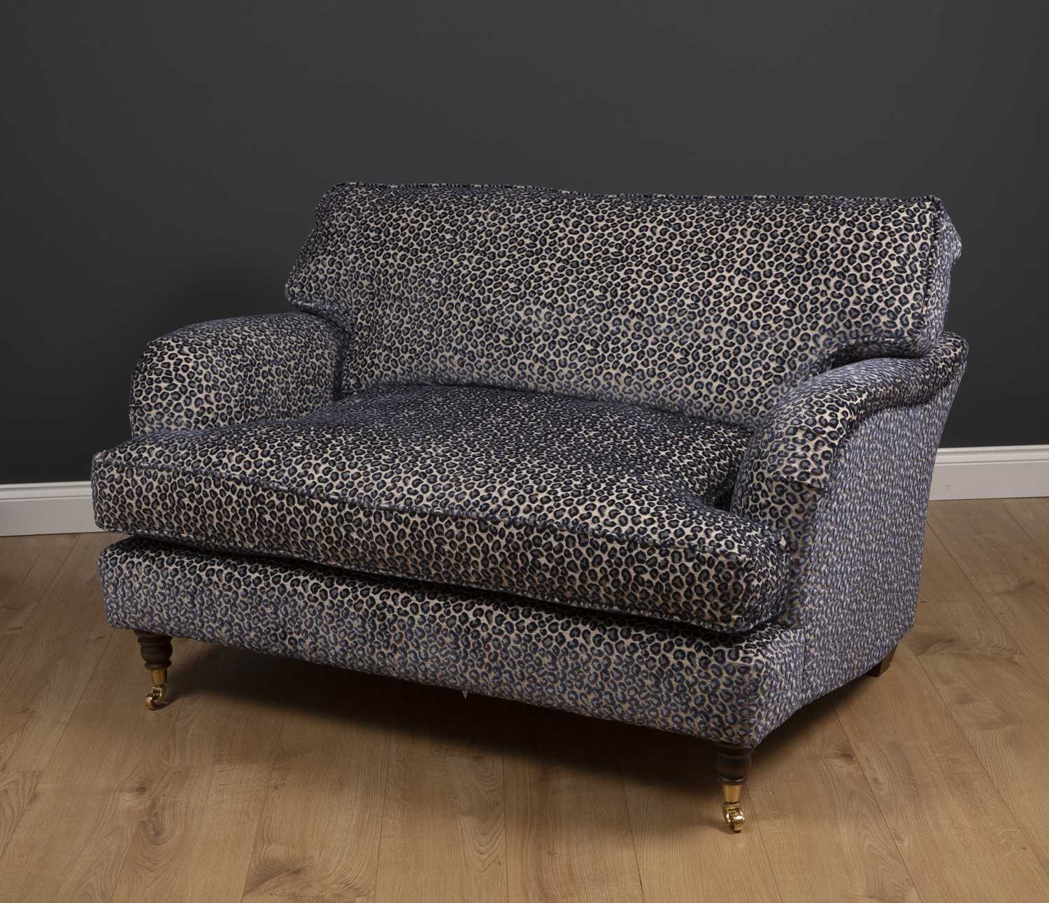 A small modern deep two seater sofa with turned front legs and brass casters, upholstered in lilac - Image 2 of 4