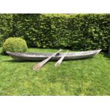 An antique dugout canoe, with two paddles, possibly South American, 328cm long x 43cm wide x 33cm