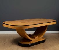 An art deco style burr maple wood veneered dining table with rounded ends, the U shaped support on