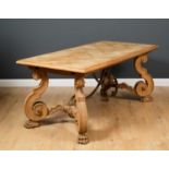 A continental oak dining table with parquetry inlaid top, carved scrolling supports to each end with