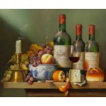 Raymond Campbell (b.1956) still life with wine bottles, fruit, cheese and a candlestick on a
