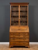 A George III mahogany bureau bookcase with astragal glazed doors to the upper section enclosing