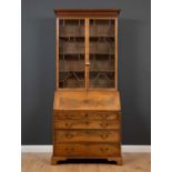 A George III mahogany bureau bookcase with astragal glazed doors to the upper section enclosing