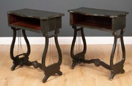 A pair of dark green painted occasional tables with serpentine tops and lyre supports to either end,