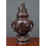 A Japanese bronze temple vase and cover, the pierced lit surmounted by a dog of Fo, the body