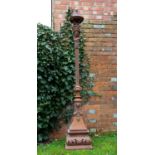 A Victorian cast iron torchiere of classical form with lamp support over a female mask and on