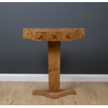 An art deco style marble topped serpentine console table with three drawers and on a plinth base,