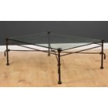 A wrought iron glass topped occasional table with tassel finials to the stretchers, 91cm wide x 44cm
