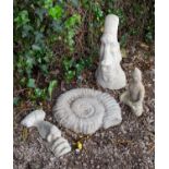 A reconstituted stone plaque in the form of an ammonite together with a small cast sculpture of