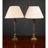 A pair of contemporary glass and brass table lamps of corinthian column form with stepped bases, the