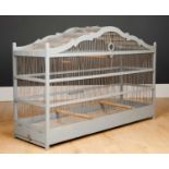 An antique grey painted bird cage on a rectangular base, 89cm long x 27.5cm wide x 56cm