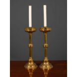 A pair of Victorian turned brass candlesticks with knoped stems, 15cm diameter x 51cm