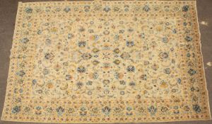 A light green ground Oriental rug with stylised flowers to the central field, set within a