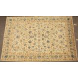 A light green ground Oriental rug with stylised flowers to the central field, set within a