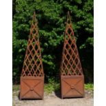 A pair of steel square planters with trellis work conical supports above, each 59.5cm wide x 227cm