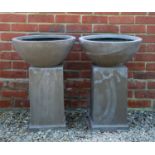 A pair of fibre clay bowls on plinth bases, the bowl 46cm diameter, the bowls and bases standing