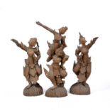A group of three Thai carved hardwood figures of dancers each possibly originally supporting