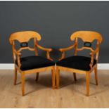A pair of contemporary Biedermeier style open armchairs with ebonised wreath splats and black