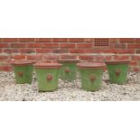 A set of five green glazed terracotta circular tapering planters each decorated with a roundel, 28.