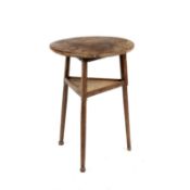 An antique oak circular small size occasional cricket table the turned legs united by an