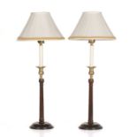 A pair of George III style mahogany and brass table lamps with fluted column supports and turned
