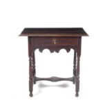 An 18th century and later oak side table with single frieze drawer, shaped frieze and turned legs
