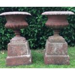 A pair of antique cast iron Campana urns and bases, with egg and dart decoration too the rim49cm