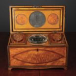 A George III satinwood tea caddy with decorative crossbanding and stringing, the fitted interior