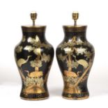 A pair of black lacquered papier-mache table lamps of baluster form with gilded chinoiserie