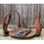 A sculptural gas fired garden brazier or fire pit the circular shallow bowl with gas burners and