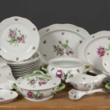 A Herend porcelain part dinner service each piece decorated with pink ornamented flowers, the