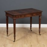 An early 19th century mahogany library or games table in the manner of Gillows, with reversible