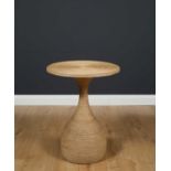 A circular string covered occasional table with shaped support, 51cm diameter x 67cm highCondition