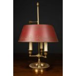 A brass bouillotte style table lamp with three lights, painted toleware adjustable shade, and with