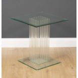 A contemporary square glass occasional table with multiple supporting stems to the centre and on a