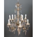 A decorative French style twelve light chandelier with pointed finials to each arm and with cascades