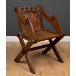 A 19th century oak gothic revival Glastonbury chair, 66cm wide x 50cm deep x 84cm high at the back x