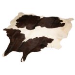 A modern black and white cow hide rug 193cm x 195cm (maximum)Condition report: Minor marks overall